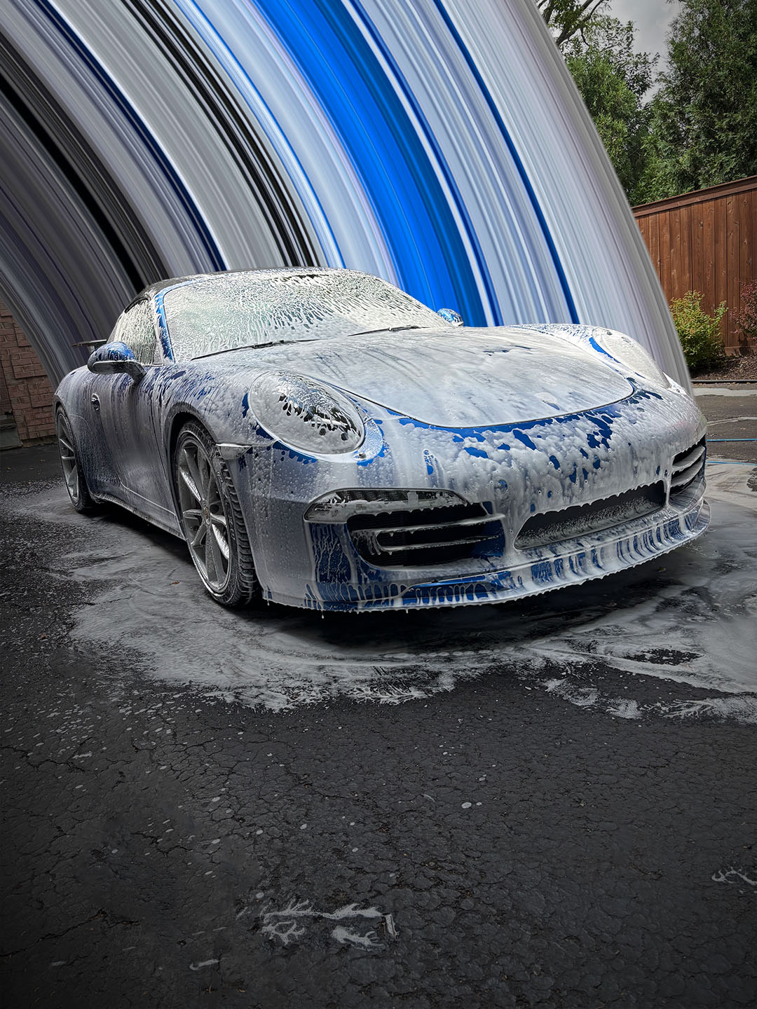 Porsche 911 covered in thick foam during a hand wash by Lucent Car Care