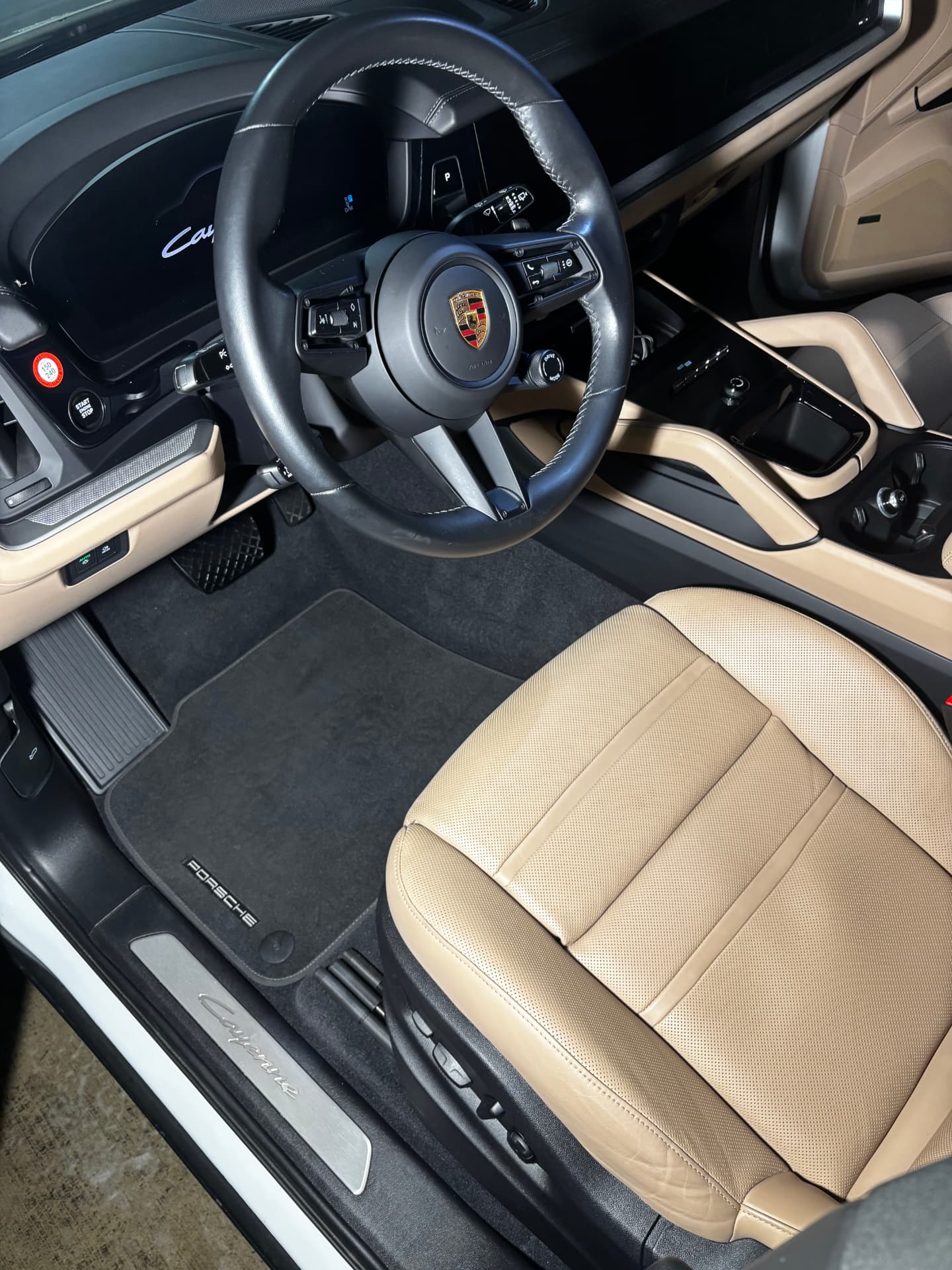 Cream leather seats and clean floor mats in a Porsche after an interior detail