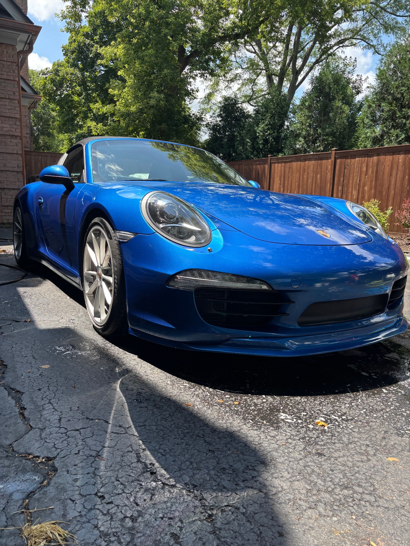 Detailed blue Porsche 911, front exterior view with glossy clean finish