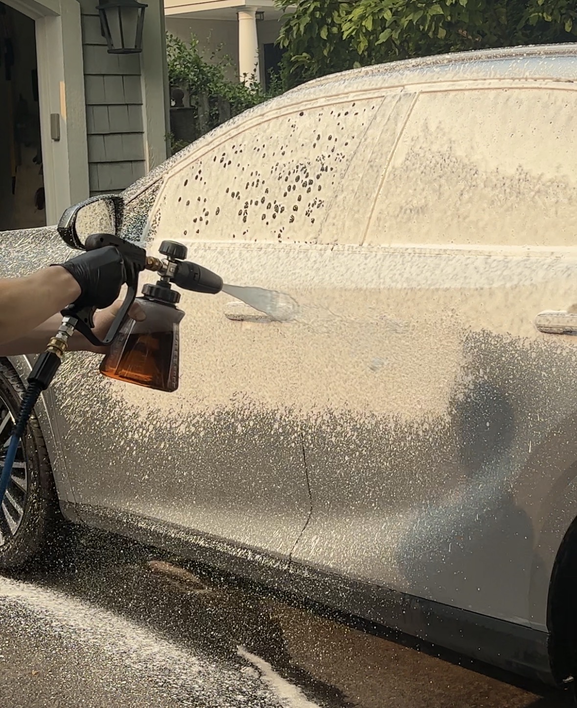 Foam cannon washing a car during a mobile detail on the North Shore