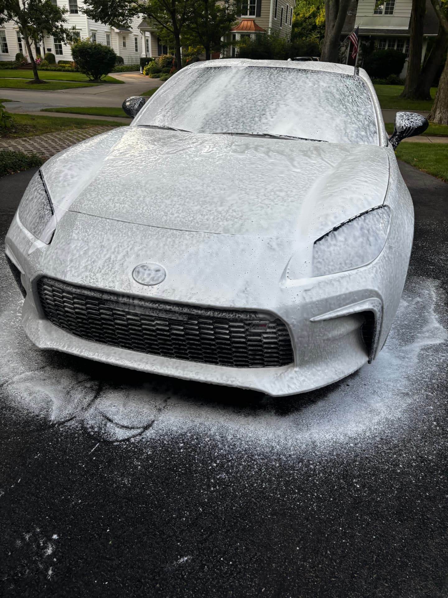 Toyota GR86 covered in foam during a mobile detail in a North Shore driveway