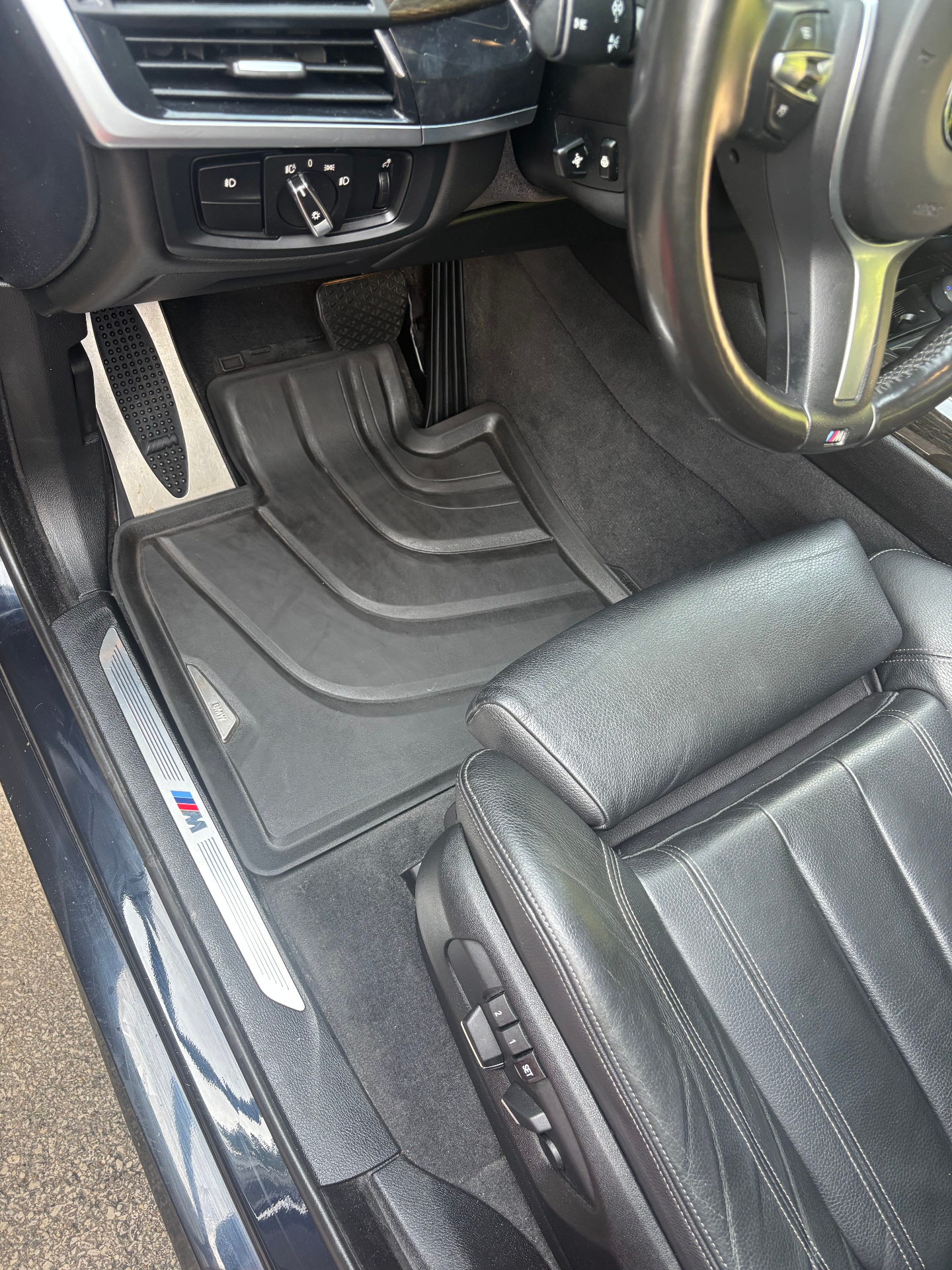 Detailed black interior floor mats and pedals after vacuuming and cleaning