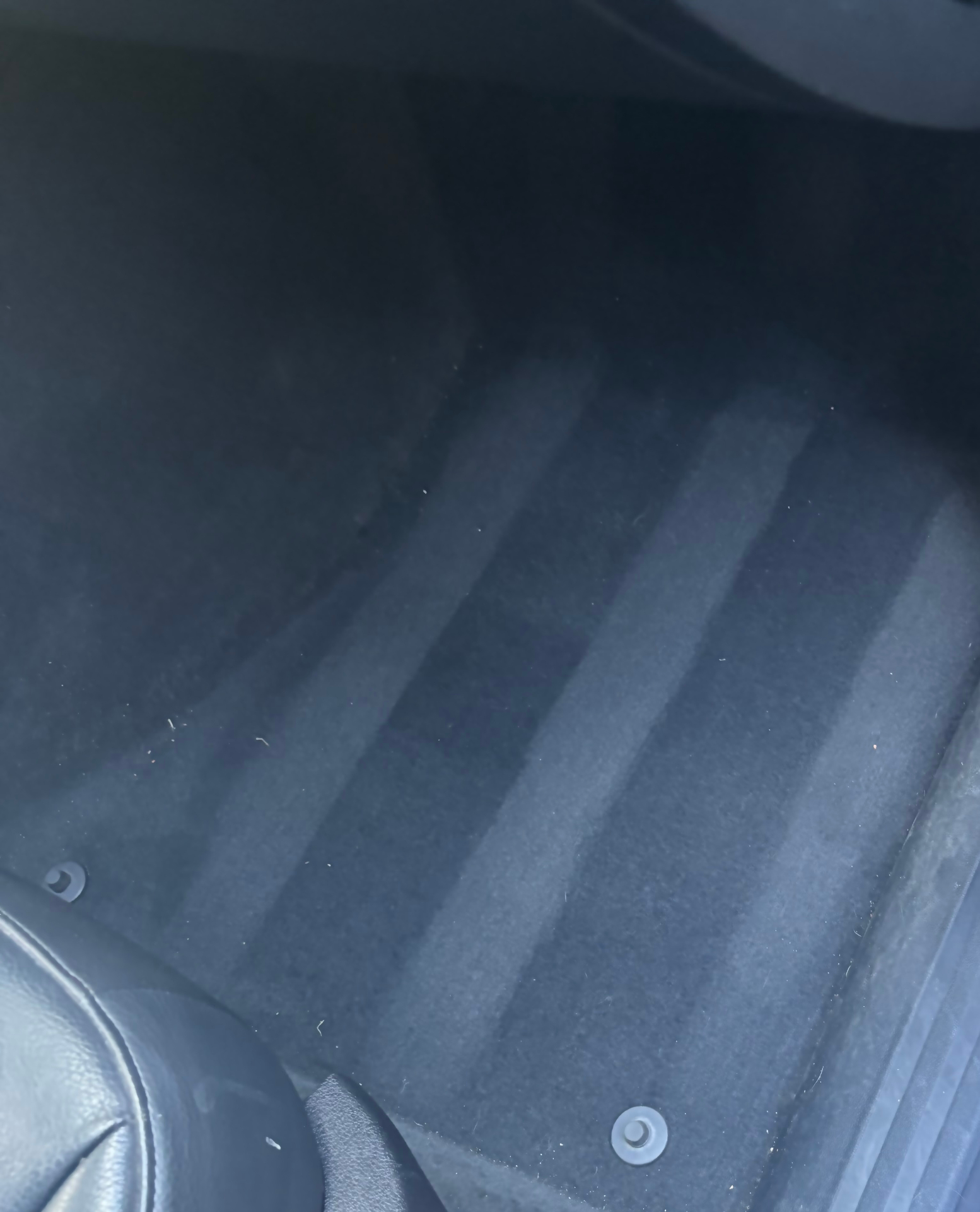 Vacuumed car trunk carpet showing clean, even vacuum lines